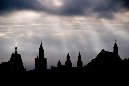 Dark silhouetts of cathedrals against evening skies in Maastricht, Netherland.の写真素材