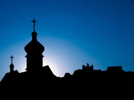 Dark silhouettes of orthodox cathedral against blue skies の写真素材