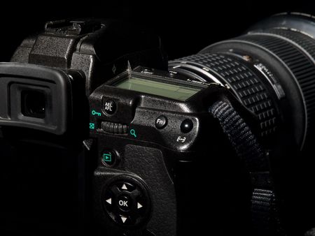 Digital photo camera from back side in dark tone.の写真素材