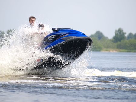 Couple men on jet ski jupm on the waveの写真素材