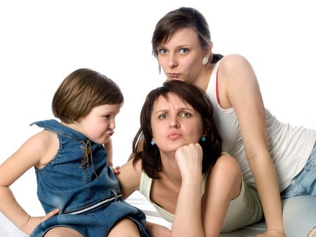 Joy mother and two daughters play as frownedの写真素材