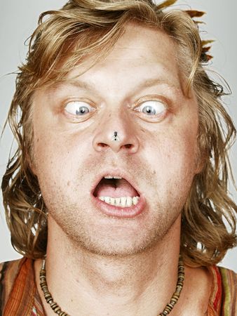Portait of man with a fly on his nose の写真素材