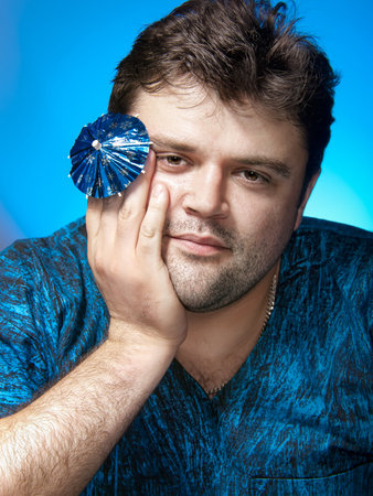 Portrait of tranquil man with cocktail umbrellaの写真素材