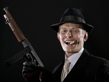 Laughing man like a chicago gangster with Thompson submachine gunの写真素材