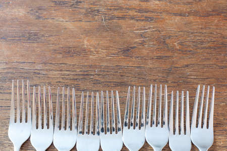 Several rustic forks on old wooden table - copy space.の写真素材