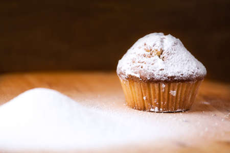 Homemade cupcakes on a wooden cutting board.の写真素材