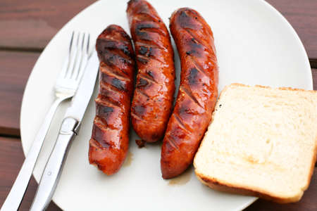 Barbeque sausages on wooden tableの写真素材