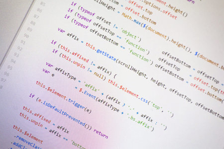 Colorful programming php and html source code on a monitor written by a young programmer.