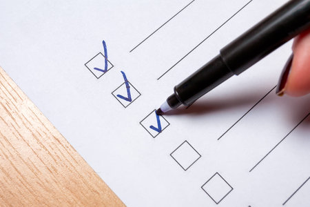 To do checklist on a light floor - girl ticking the box with a marker.