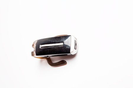 Vintage obsolete scratched bluetooth headset isolated white.