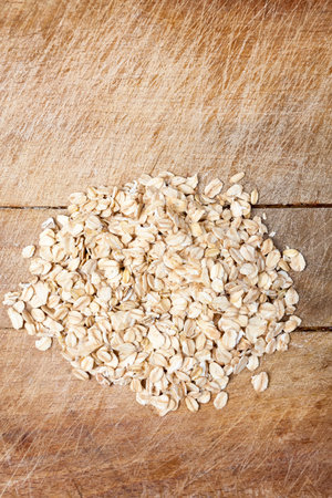 Raw oats wooden cutting board  background package.