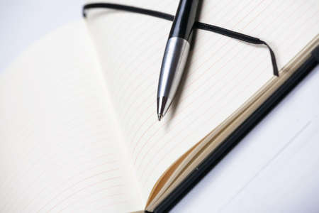 White notepad notebook lines elegant pen gray wooden backgroundの写真素材