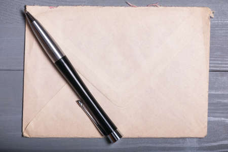 Old vintage elegant business pen letter sheet paper grey wooden background flatlayの写真素材