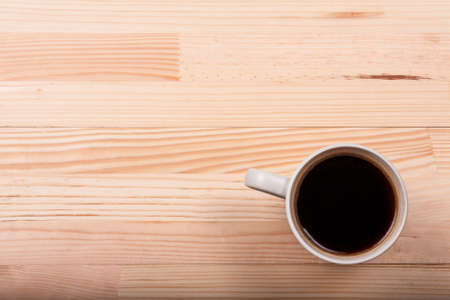 Black coffee laptop notebook business generic phone natural wooden light background top viewの写真素材