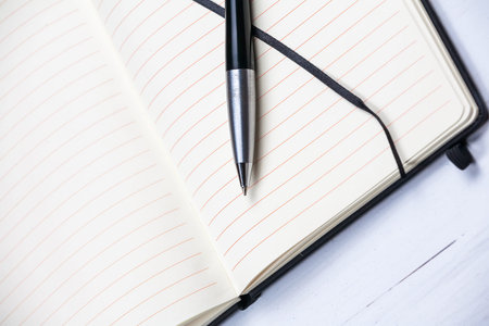 White notepad notebook lines elegant pen gray wooden backgroundの写真素材