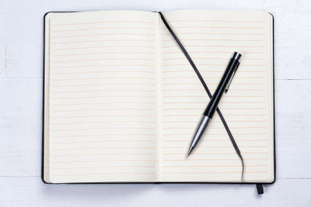 White notepad notebook lines elegant pen gray wooden backgroundの写真素材