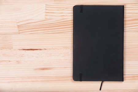 Elegant business black notepad light wooden natural background top view flatlayの写真素材
