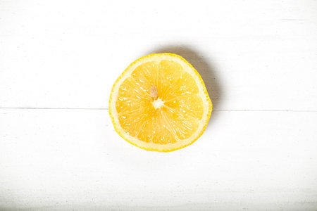 Yellow sunny half lemon white natural vintage wooden background