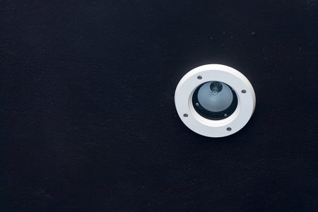 White office modern light on a black painted ceilingの写真素材