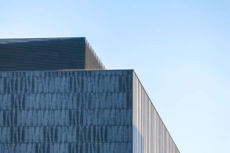 Modern business building part against blue sky background.の写真素材