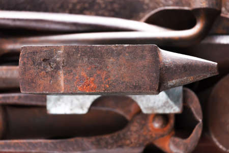 Old rusty rugged anvil on other blacksmith tools. Top view.の写真素材
