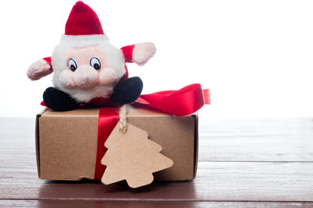 Funny christmas santa claus red and black mascot. Present or gift with red ribbon bow. White...
