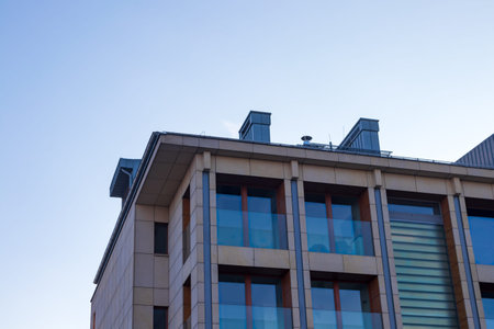 Modern luxury residential building against a blue sky.