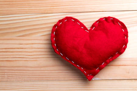 Red heart on natural wooden table on Valentine's Day. Copy space on the left.の写真素材