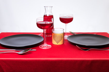 Elegant table setting in a restaurant on Valentine's Day. Wine and candle. Romantic dinner for two abstract concept.の写真素材