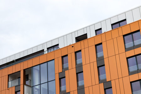 Modern red and white residential building in the city.