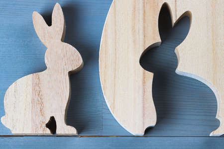Spring easter bunny figurine on natural grey wooden background. Flat lay top view.の写真素材