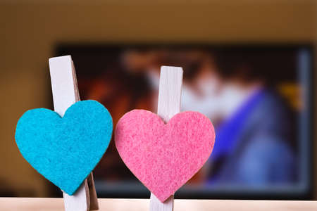 Blue and pink hearts on a clips against romantic movie background. Love and togetherness abstract concept.の写真素材
