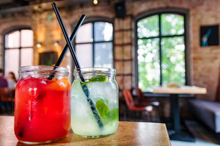 Fruit juice and lemonade with ice in a restaurant. Summer refreshment concept.の写真素材