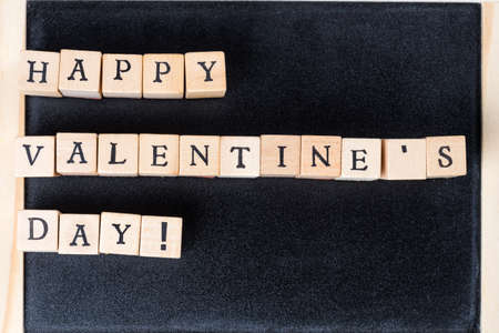 Happy Valentines Day caption on a blackboard. Closeup. Copy space on the bottom right.の写真素材