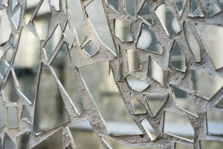 Shards of a mirror glass pattern on a wall.