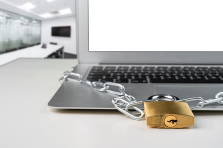 Padlock and chain with laptop computer in a presentation board office room. Cyber security abstract...