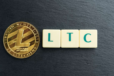 Physical Litecoin gold coin with text made out of letter tiles. Cryptocurrency.の写真素材