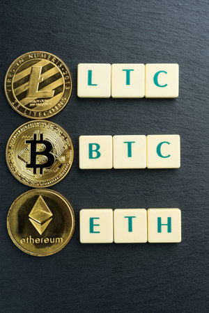 Physical Bitcoin, Litecoin and Ethereum gold coins with text made out of letter tiles....