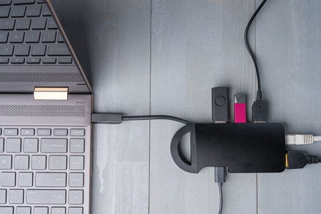 USB Type C adapter or hub connected to the laptop with various accessories - pendrives, hdmi,  ...