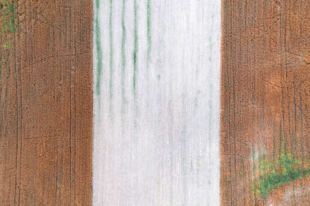 Aerial top down drone shot of interesting pattern on a rural countryside crop fieldの写真素材