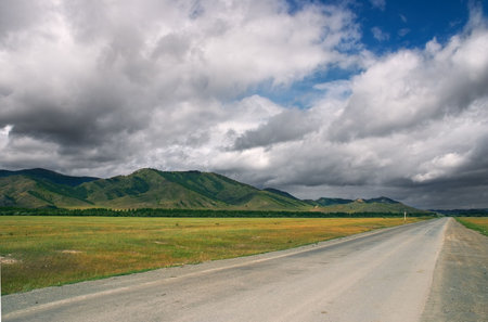 Road, mountains and skiesの写真素材