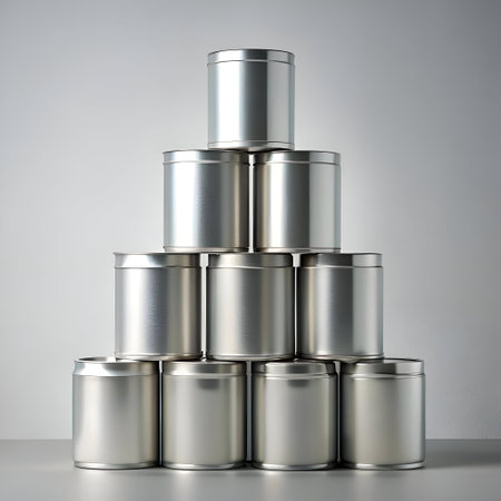A pyramid of eight sleek. silver cans. arranged in a visually appealing and organized manner. against a clean white background. Perfect for showcasing your brand or product. or for adding a minimalist touch to your design.の素材