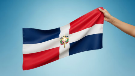Dominican Republic flag held by a hand against sky.の素材