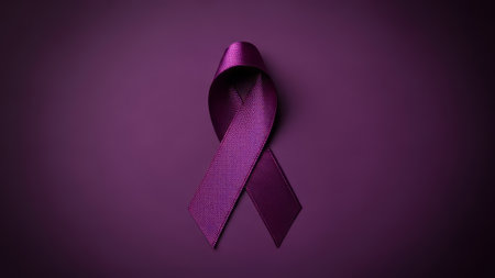 Purple awareness ribbon on textured purple background.の素材