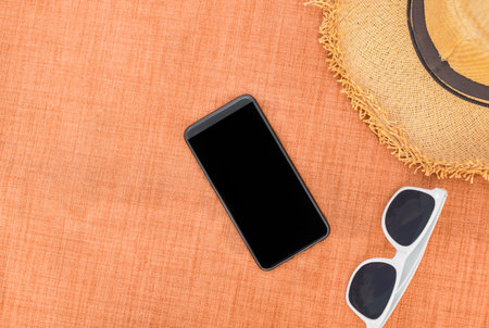 Summer accessories of holidays and travel concept on orange background.