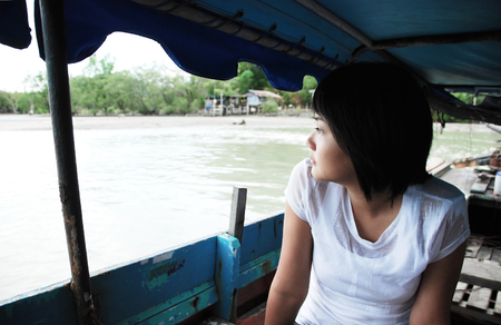 Young woman traveling by boatの写真素材