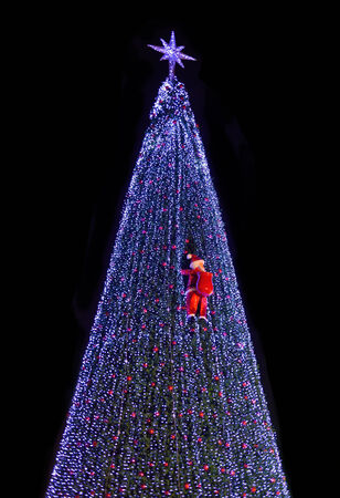 Santa climb on christmas treeの写真素材
