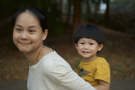 Young boy on back of his mother : Soft focusの写真素材