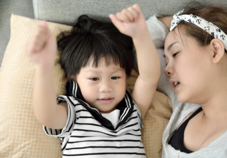 Young mother and child playing and singing