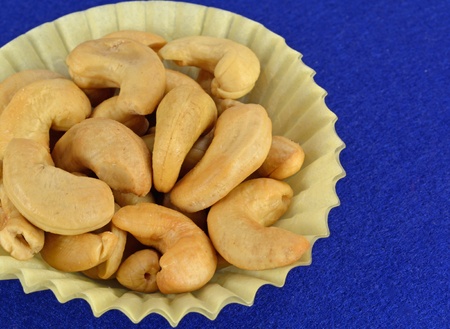 Shelled Cashews in a yellow paper cup.の写真素材